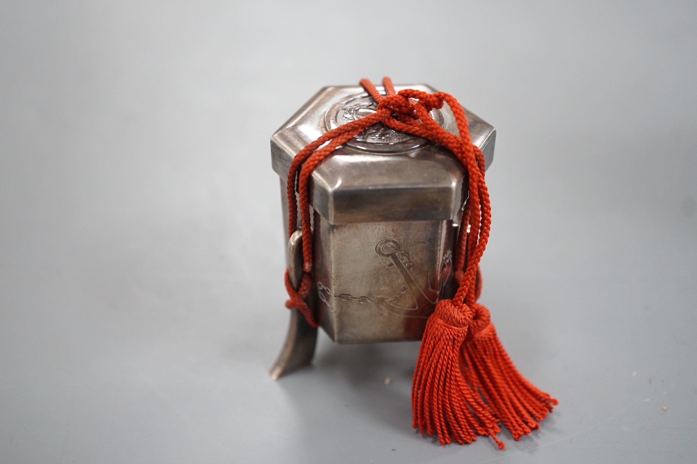An early 20th century Japanese white metal hexagonal box and cover, signed to the base, height 53mm, gross weight 74 grams.